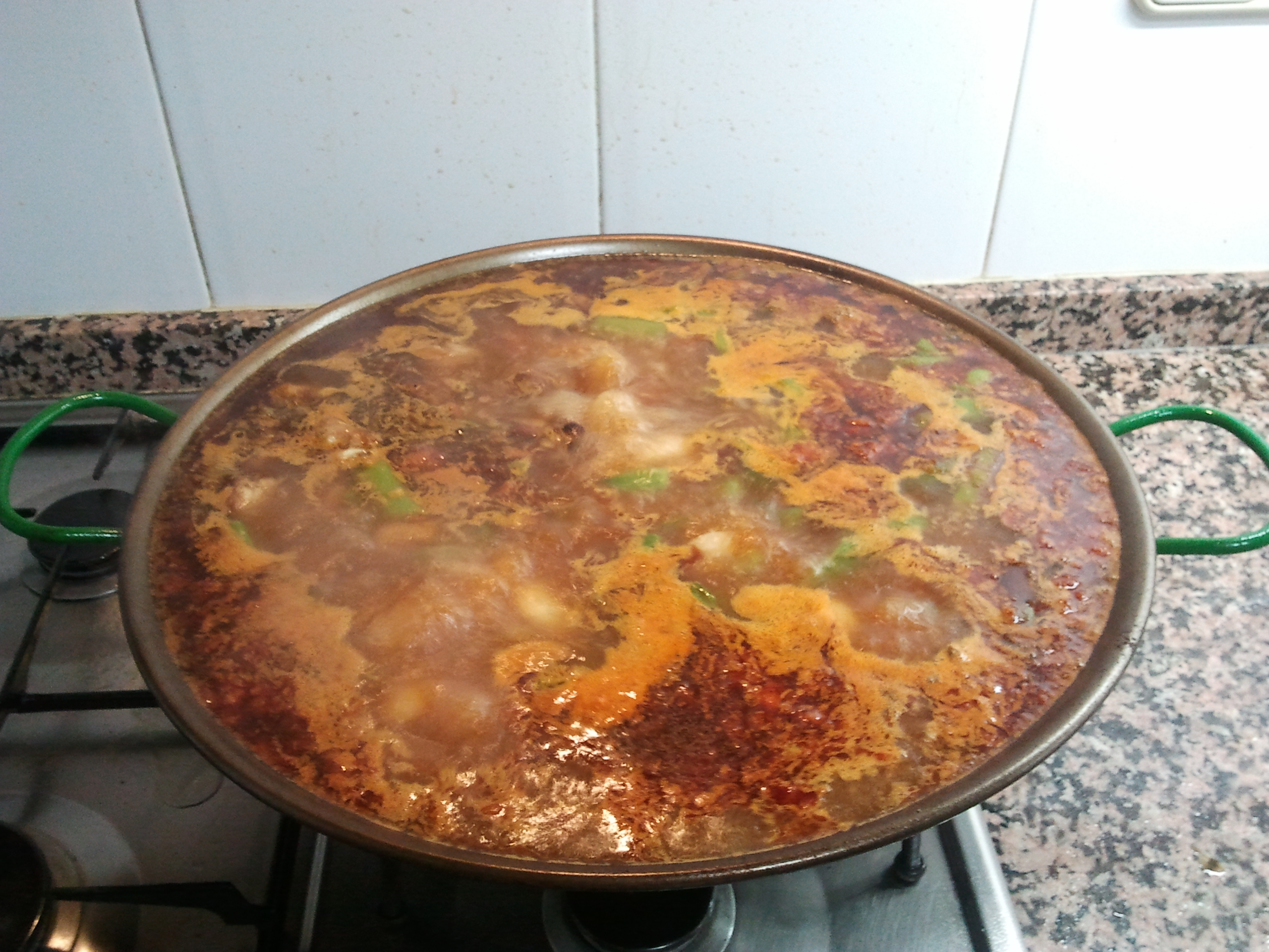 Add water to Paella and let it cook