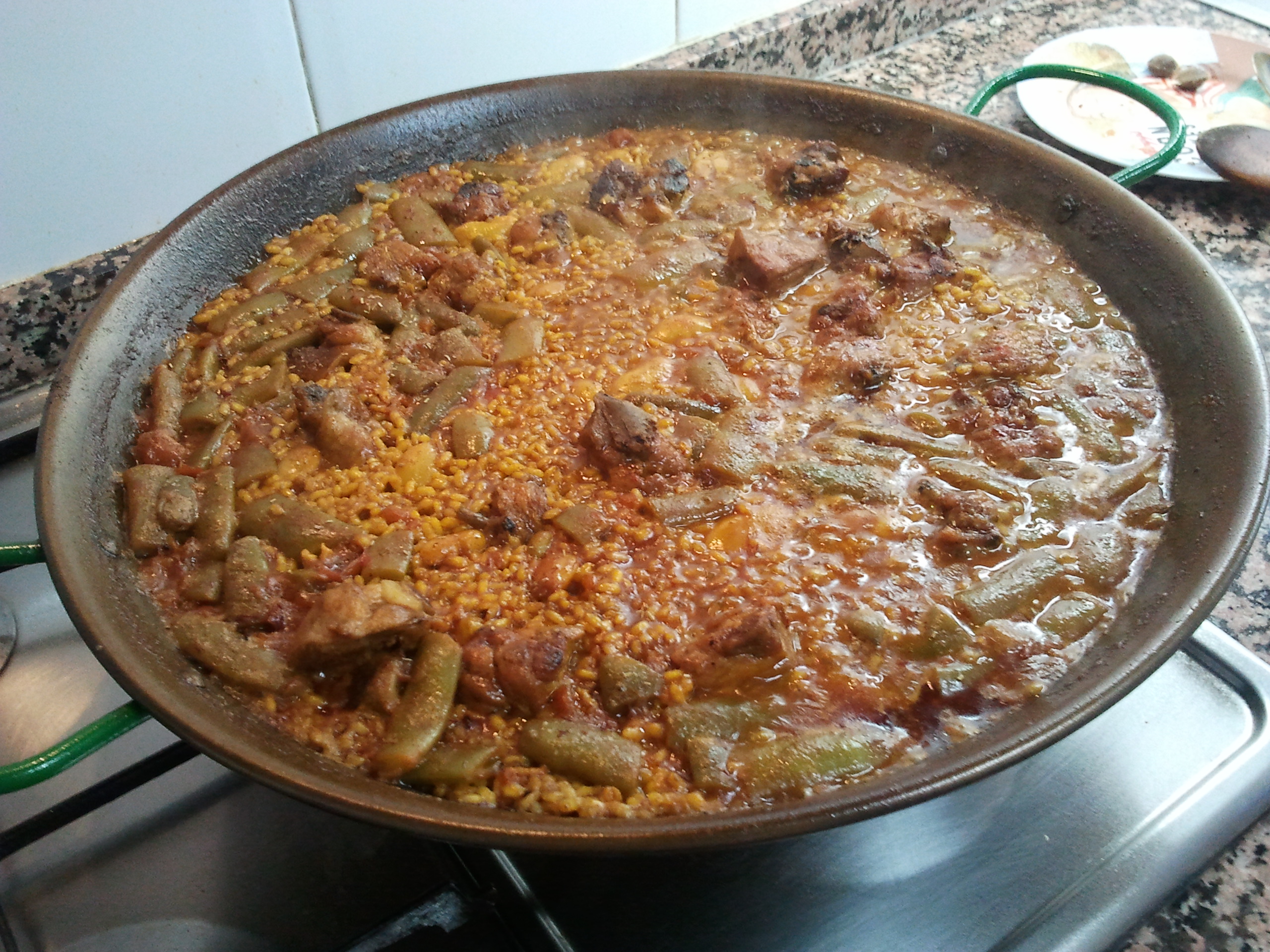 Half cooked paella with some liquid